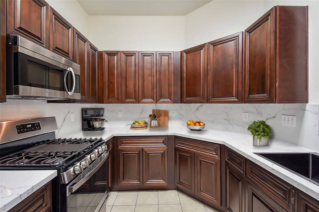 The sleek marble countertops provide ample prep space, making them ideal for cooking and entertaining. Imagine yourself confidently preparing delicious family recipes on these countertops.