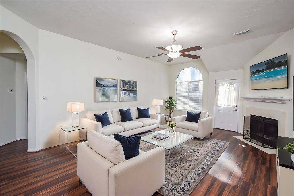 Experience this spacious living room infused with modern charm. The open floor plan offers plenty of room for furniture and decor, enabling versatile arrangements.