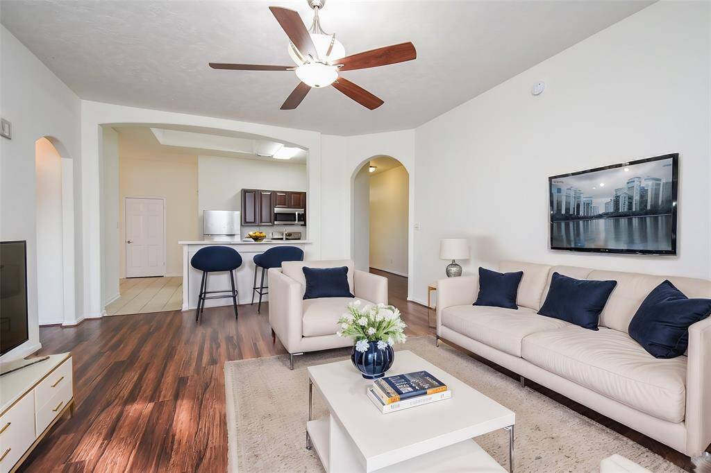 The stunning flooring features rich, dark wood that exudes warmth and sophistication, establishing a cozy ambiance.