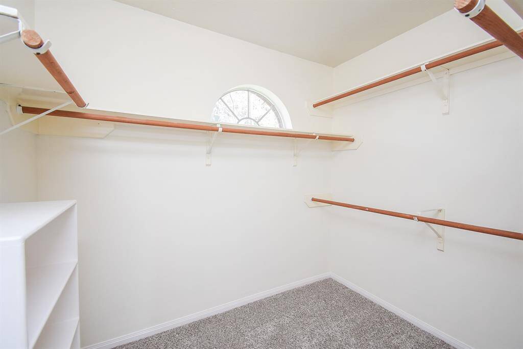 Welcome to your perfect walk-in closet, designed for both organization and style. Multiple rods provide ample space for all your clothing, from dresses to suits, ensuring that everything is easily accessible. Additionally, built-in shelving offers the perfect spot for shoes, accessories, or folded items, helping to keep everything neatly organized.