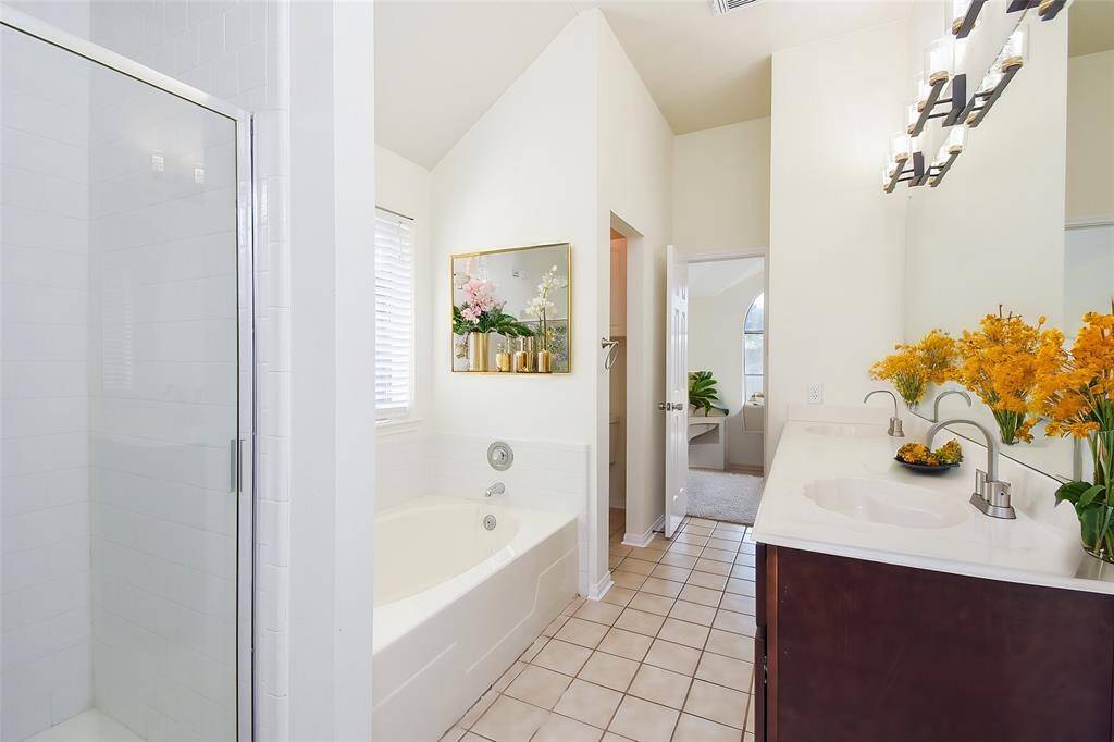 Welcome to your luxurious master bathroom, designed for relaxation and convenience.