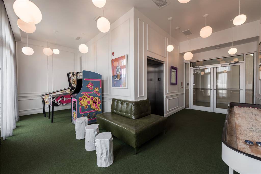 Games area with shuffleboard, pinball, and Ms PacMan!