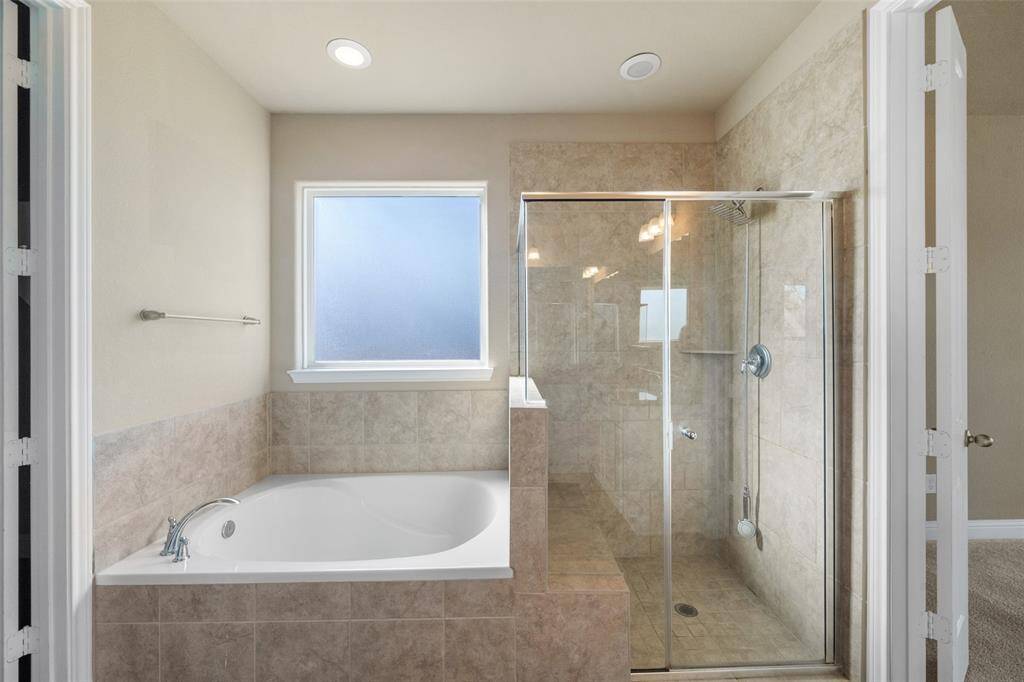 Plenty of lighting, a beautiful walk in shower and large soaking tub!