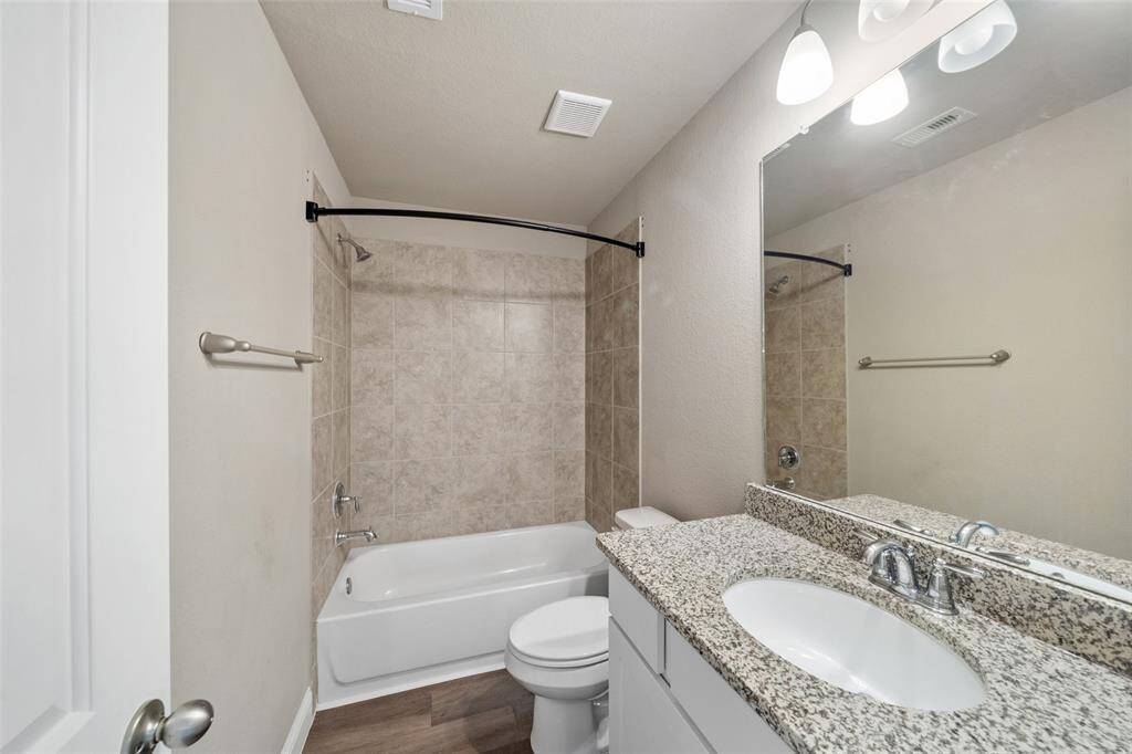 The secondary bathroom has an amazing tiled shower and a large vanity!