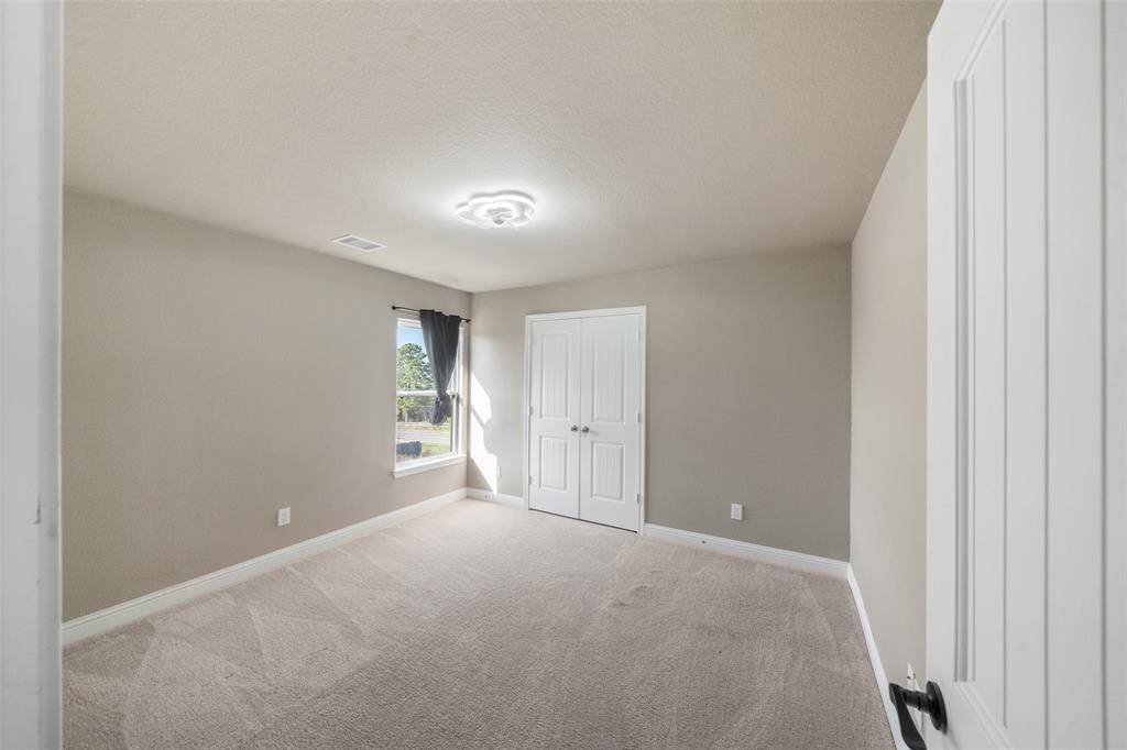 The fourth bedroom with lots of natural light and a large closet!
