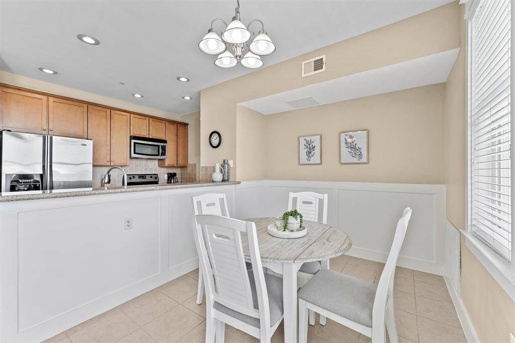 The dining area seamlessly integrates with the living room and kitchen, creating a cohesive and functional living space. This arrangement is perfect for entertaining guests or enjoying family meals, making it the heart of the home.