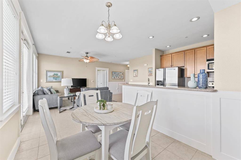 The dining space is thoughtfully positioned adjacent to the kitchen, allowing for easy access and convenience during meals. The design ensures a seamless flow between cooking and dining areas, perfect for hosting and everyday use.
