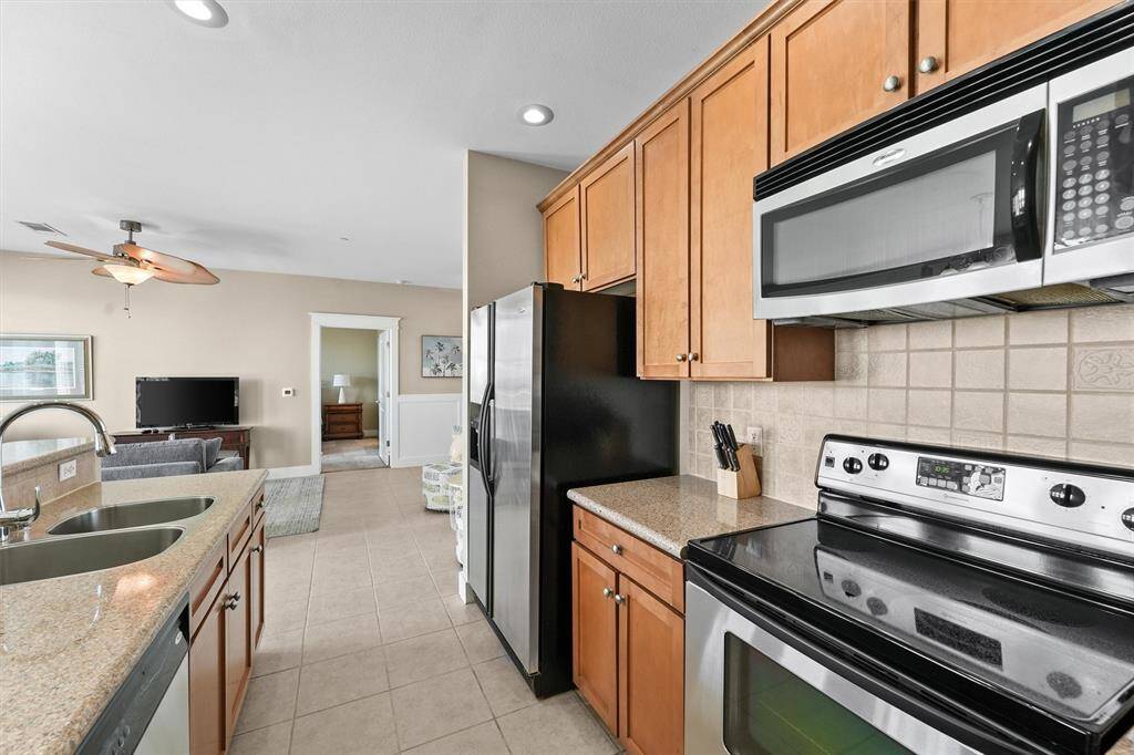High-end finishes and thoughtful details, such as a tiled backsplash, create a polished and inviting culinary space.