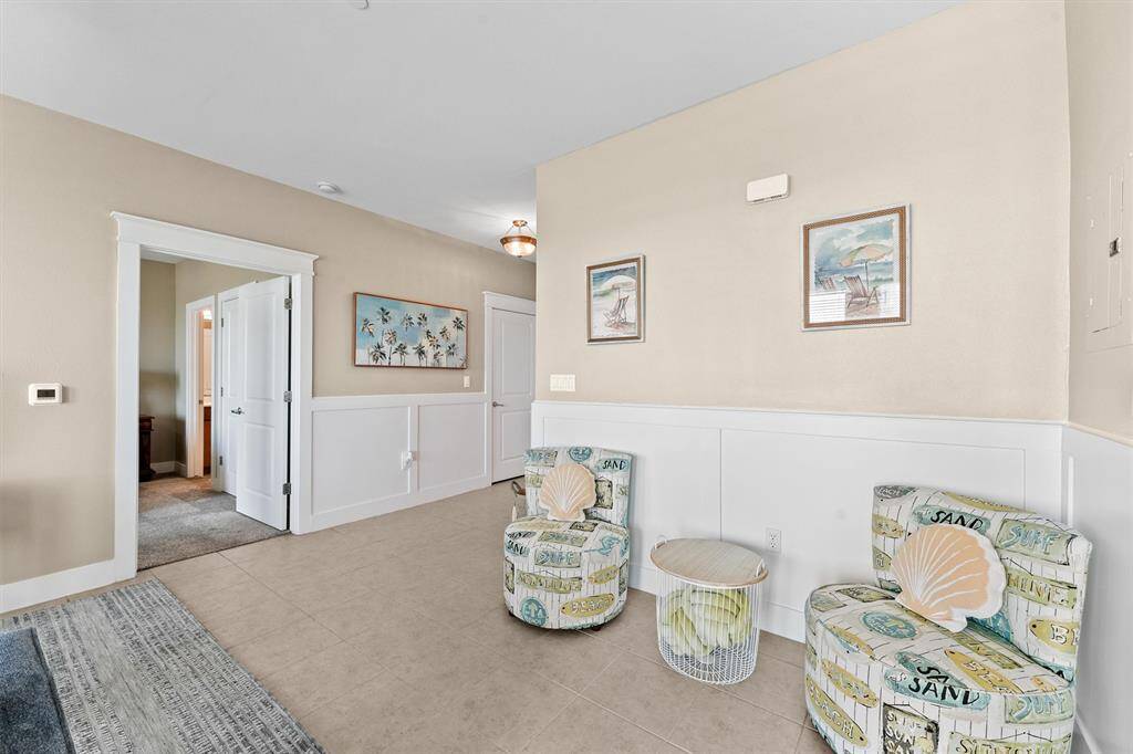 This charming nook is an ideal space for a quiet retreat or additional seating. The wainscoting adds a touch of elegance.