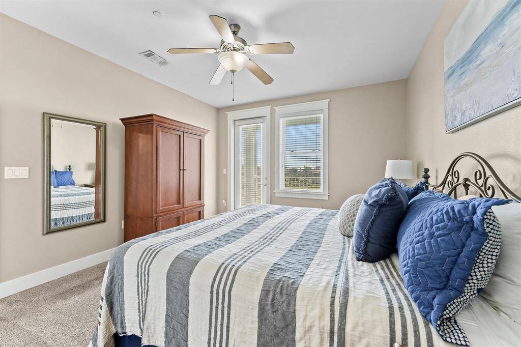 Enjoy the comfort of a spacious primary bedroom featuring high ceilings and a ceiling fan for added comfort. The room is perfectly positioned to capture views of the surrounding landscape.