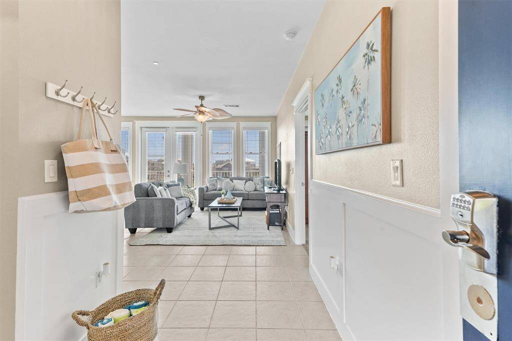 Welcome home to this inviting foyer, featuring elegant wainscoting and a practical tile floor for easy maintenance. The entryway seamlessly leads into the bright and airy living area, creating a warm and welcoming first impression.