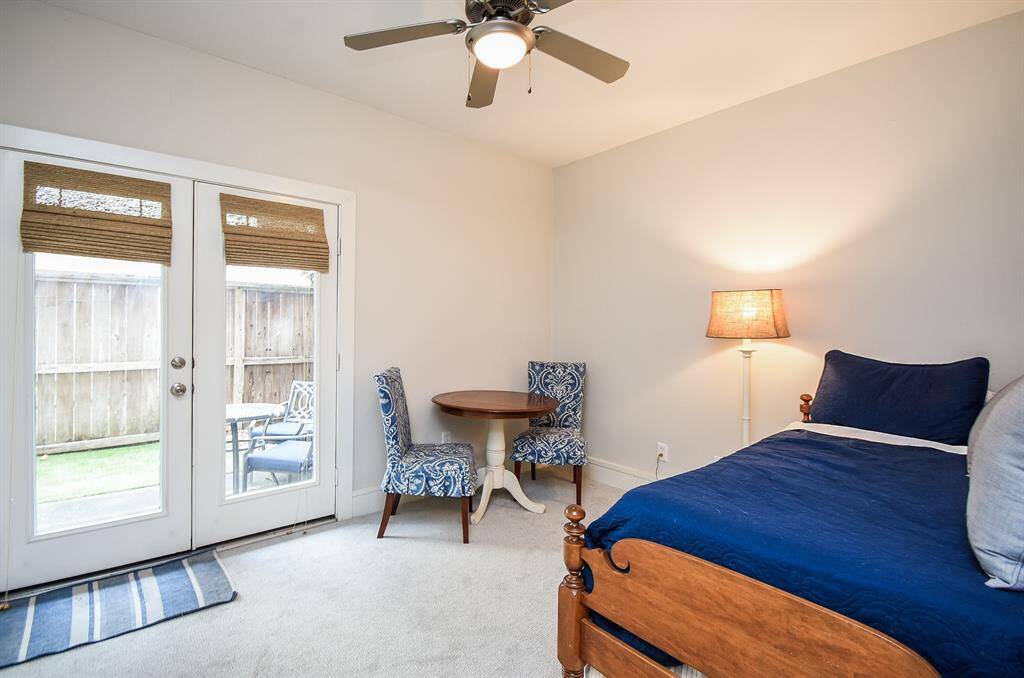 This secondary bedroom has doors leading to the turfed patio.