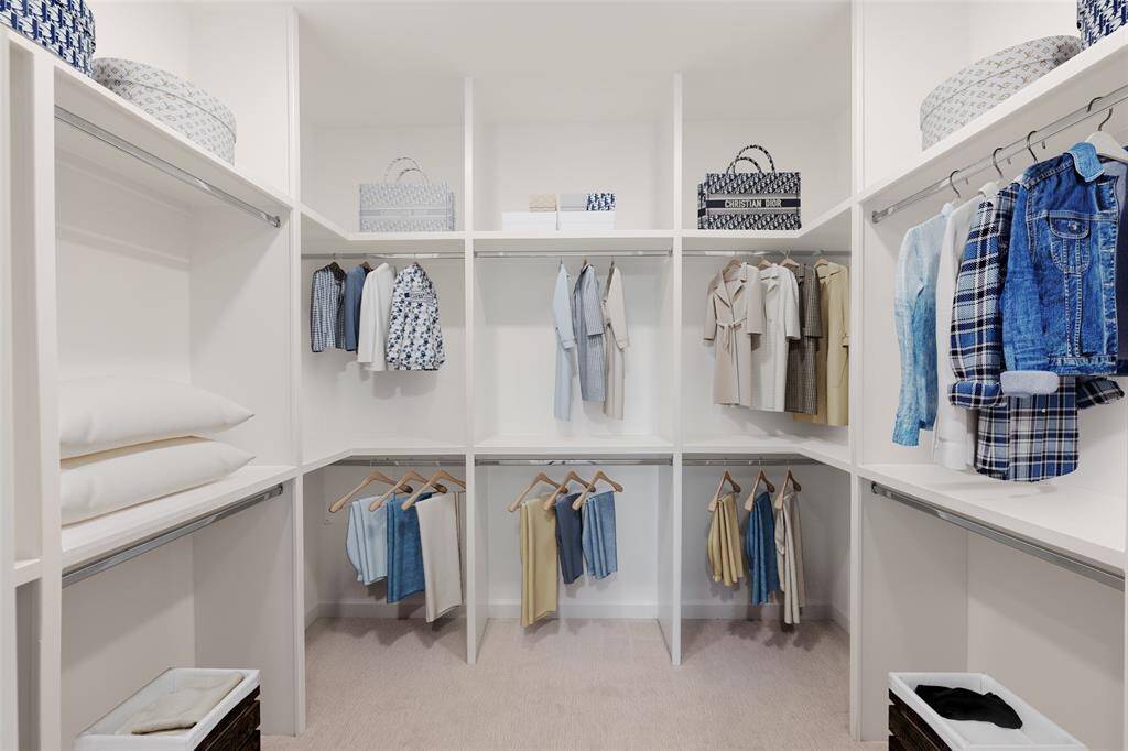 Spacious cutom closet with steel rods and plush carpet. (virtually staged)