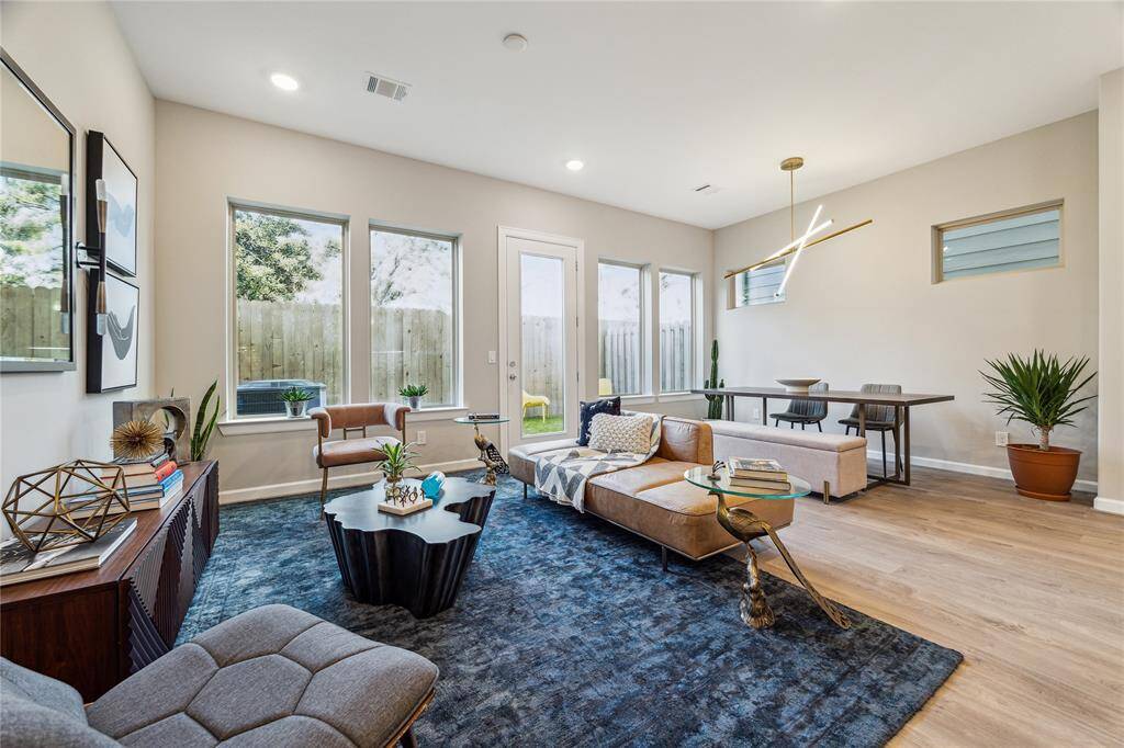 Combined and flexible living and dining spces overlooking private back yard has many windows and French door brining in natural light.