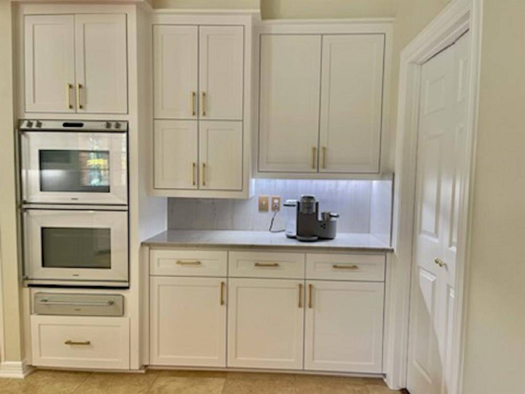 Sleek coffee bar with ample storage and modern appliances--perfect for your morning routine.