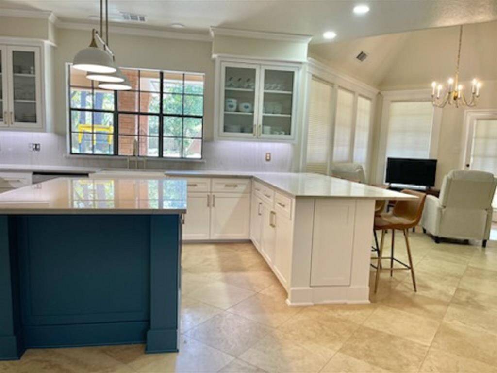 Bright, open kitchen seamlessly connects to a cozy breakfast and sitting area.