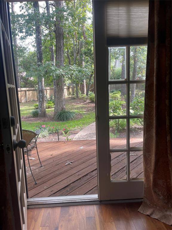 Step through the elegant French doors from the master bedroom into a serene, park-like backyard.