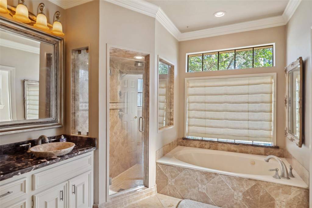 Indulge in luxury with a Jacuzzi tub and a sleek, separate shower.