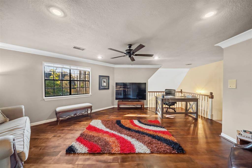 Spacious game room with convenient second staircase to the kitchen and breakfast area.