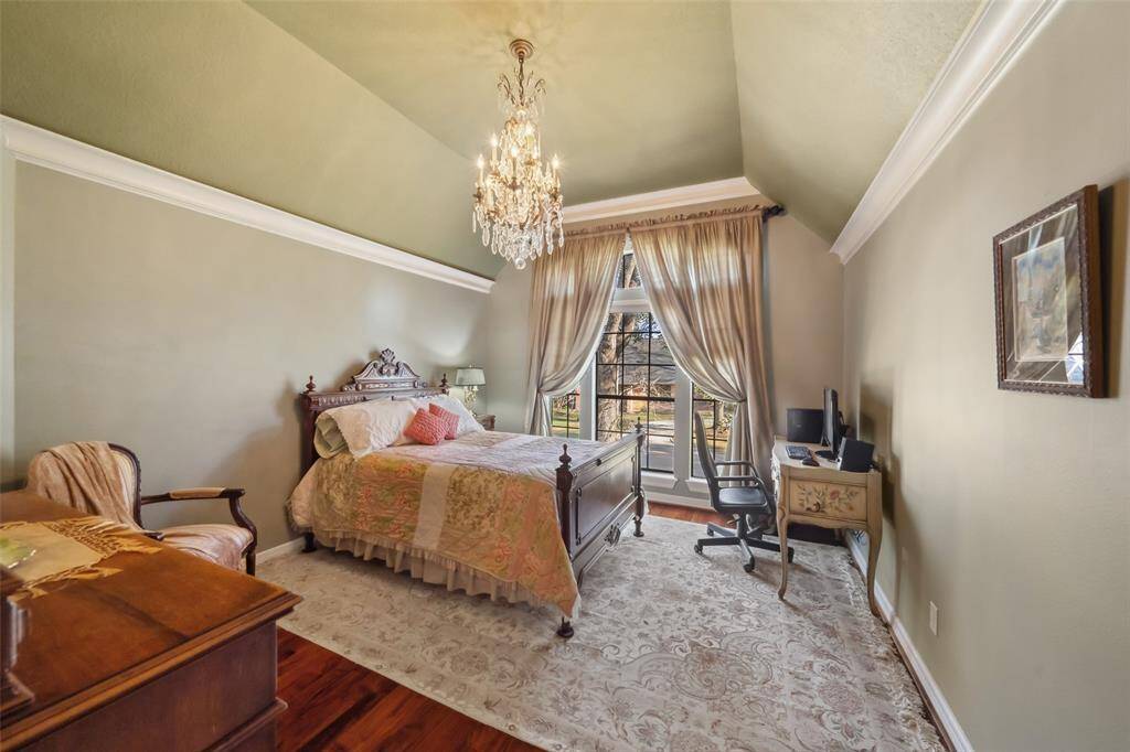 Charming guest bedroom located left of the staircase, featuring elegant decor and natural light.