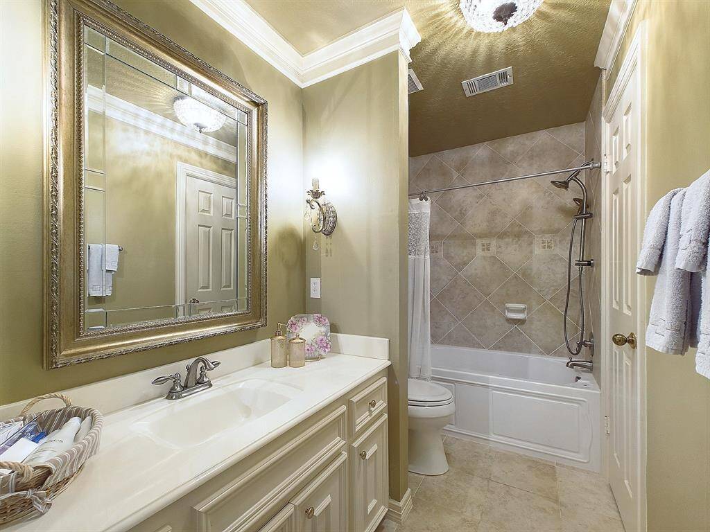 Elegant guest bathroom with ample storage in two closets.