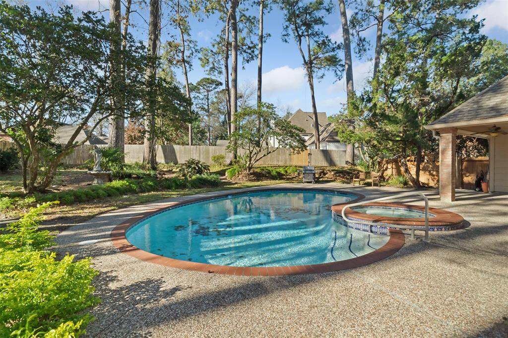 Dive into relaxation with this stunning pool and Jacuzzi combo, set in a serene backyard oasis.