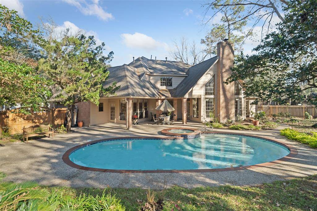 Enjoy a stunning backyard oasis with a sparkling pool and spacious patio, perfect for relaxation and entertaining.