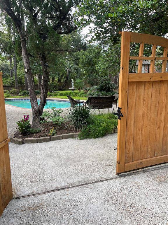 Welcome to your backyard oasis, featuring a serene pool and lush greenery.