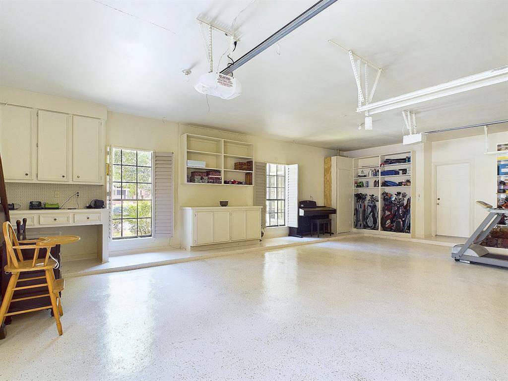 Ample built-in storage enhances this spacious garage.