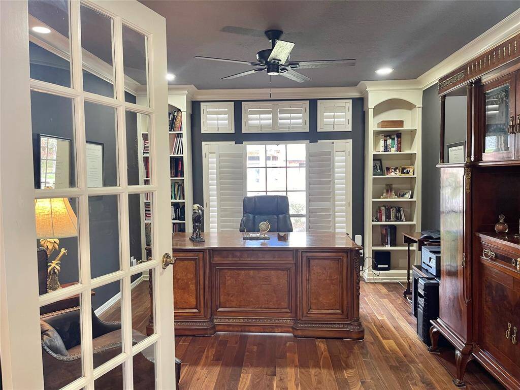 Elegant office with built-ins and French doors, conveniently located off the foyer.