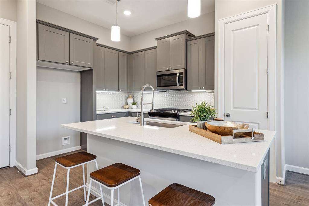 Kitchen features a dedicated pantry and pendant lightings.