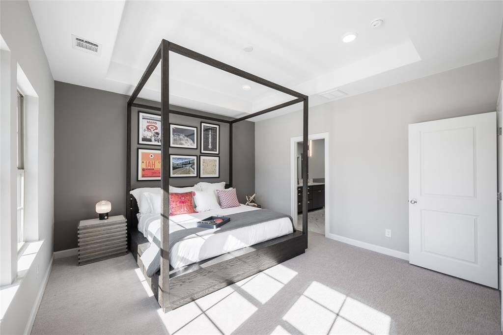 Gorgeous primary bedroom has raised ceiling and many windows to bring in natural lights.