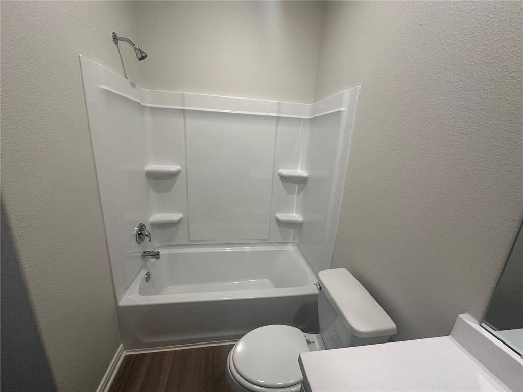 The tub/shower combo provides both a relaxing bath and a convenient shower, adding to the space’s functionality and style.