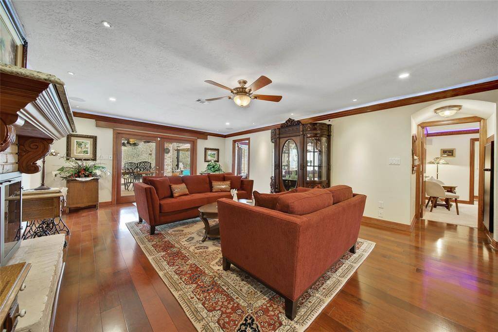 Double glass doors lead out to the covered patio area and pool. Remote control blinds.