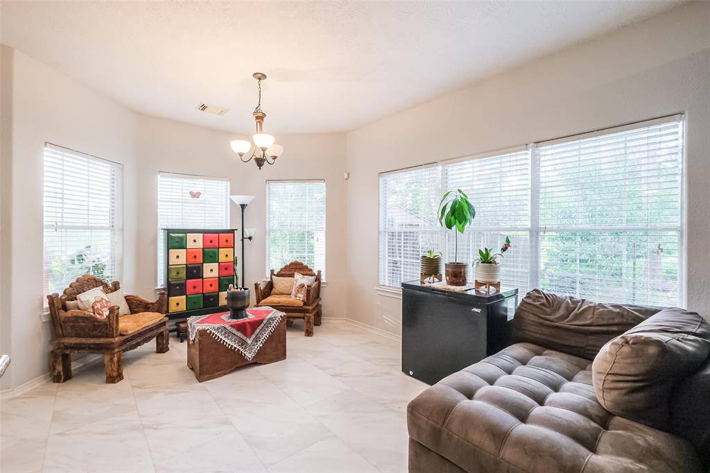 Breakfast area with large windows overlooking the spacious backyard