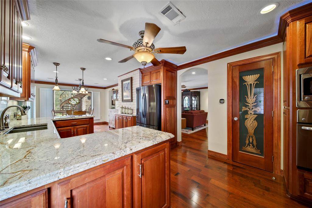 Walk in pantry with art etched door to your right. The downstairs utility room is to the right.