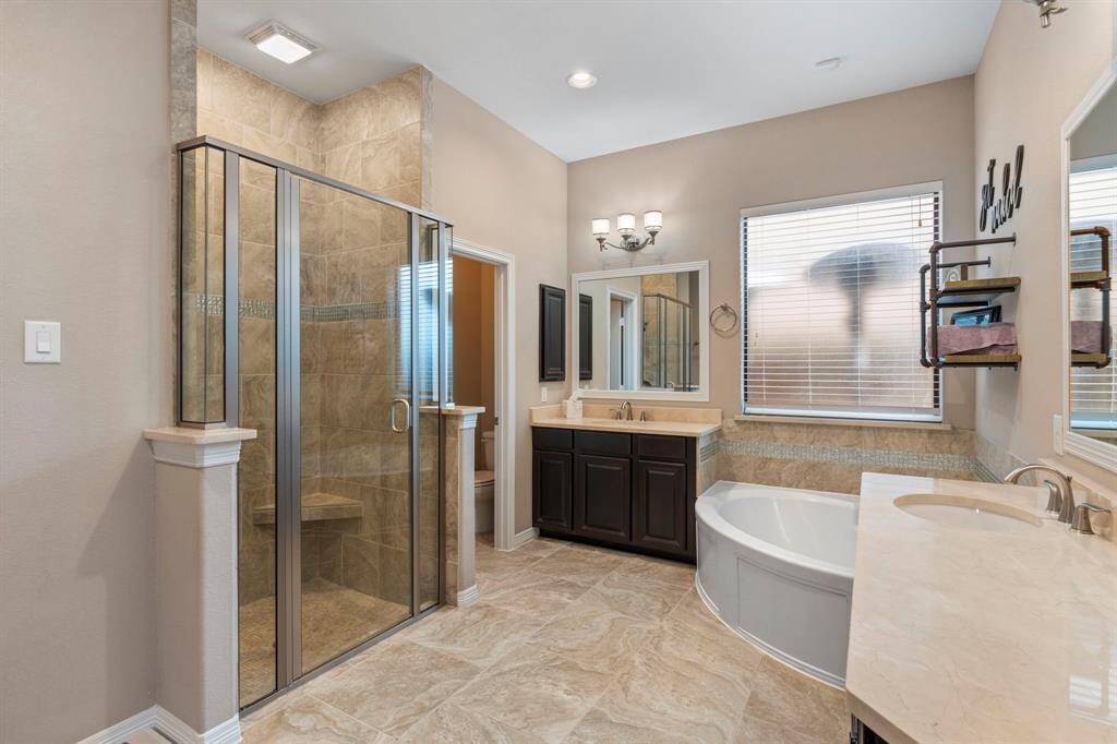 Primary bath with separate sinks and a large soaking tub.