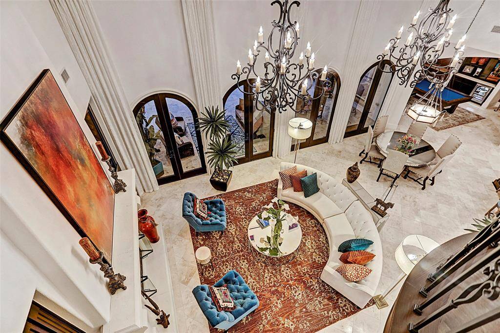 Family Room | Casual elegance comes natural in a room like this! Entertain in grand style in the family room graced by 24 foot ceilings and a dramatic stone fireplace