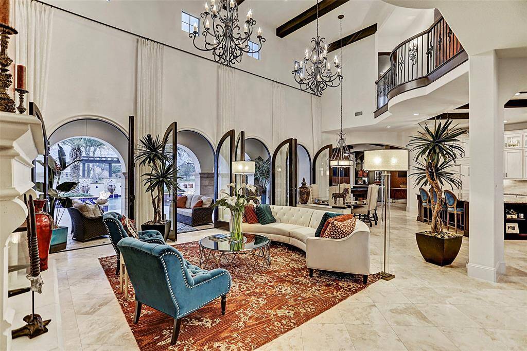 Family Room | Arched french doors seamlessly blend the indoor and outdoor living areas together and views of the resort style pool from this vantage point are breathtaking