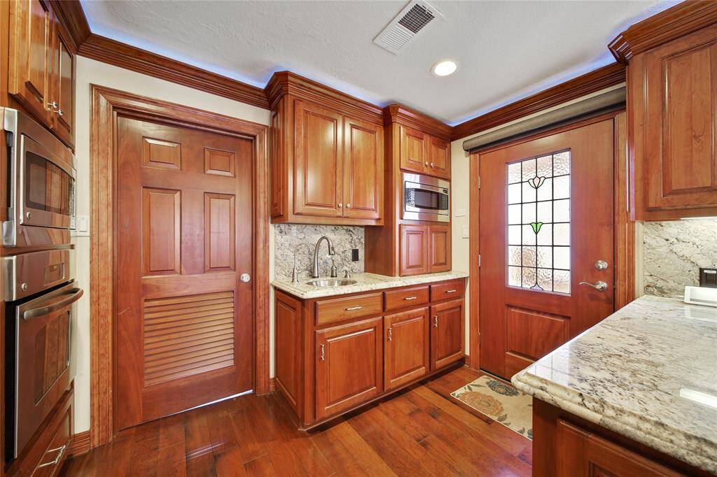 Vegetable sink or coffee bar! Door to the left leads to the downstairs utility room. Exterior door leads to the courtyard area.