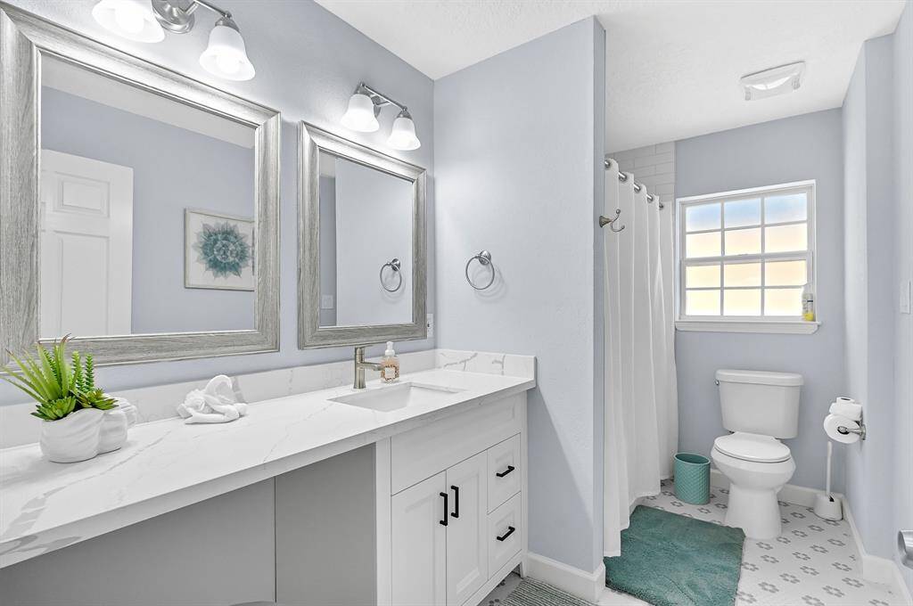 Secondary bath with tub shower combo and vanity