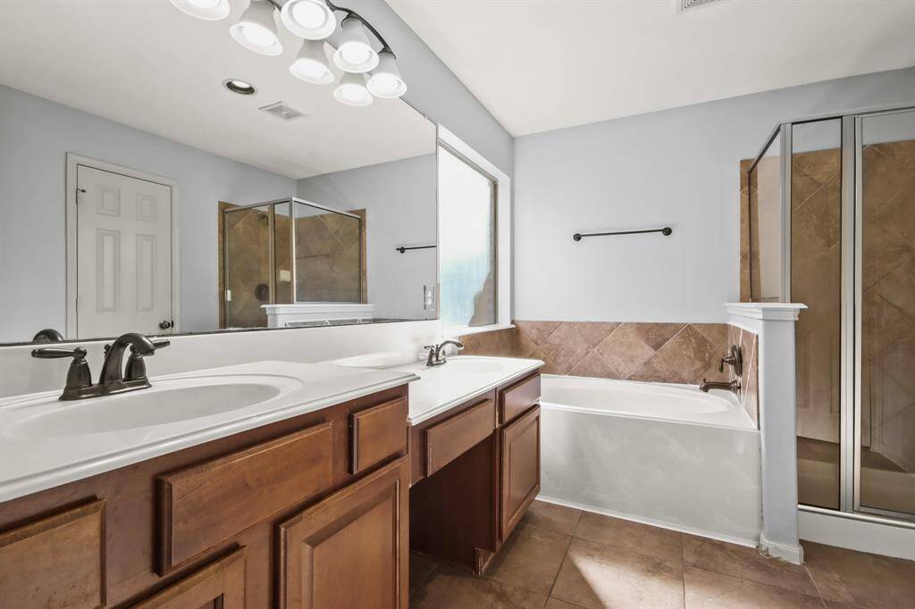 primary bathroom has tub and stand up shower