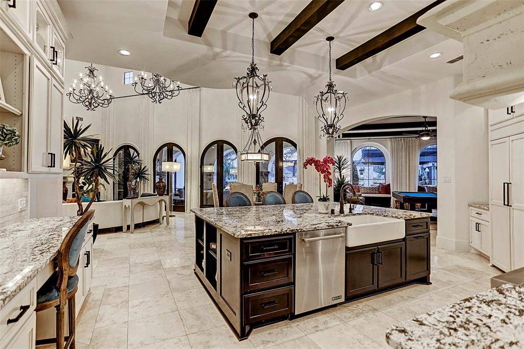 Gourmet Island Kitchen | Masterful design and modern luxury are uniquely embodied in this pretty kitchen with gorgeous custom lighting