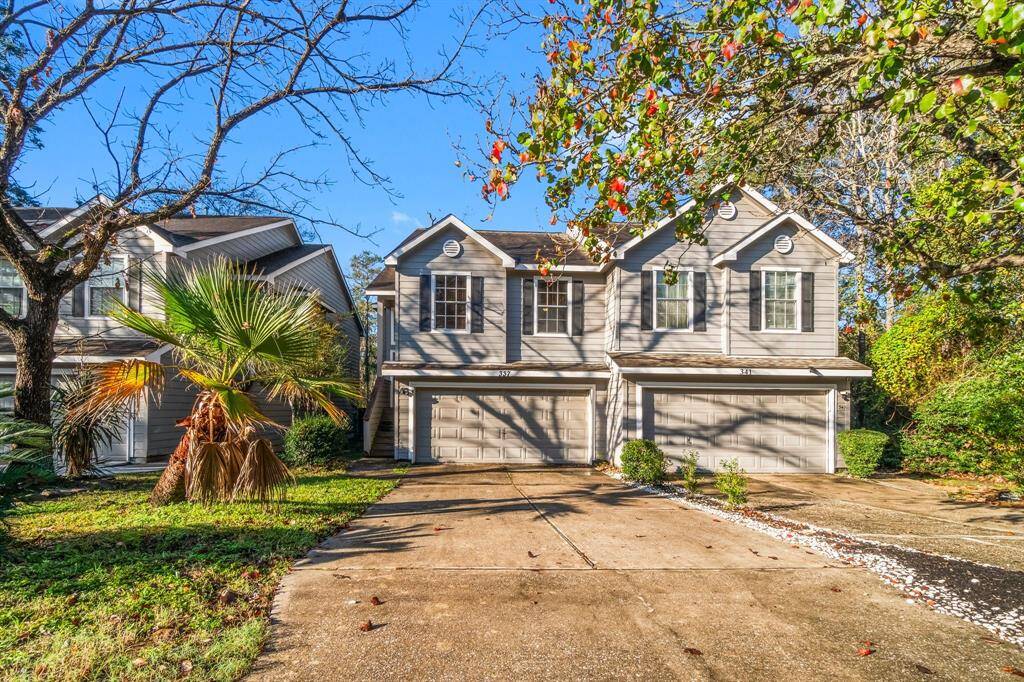 This charming two-story townhome features a double garage, a well-maintained driveway, and a lush front yard with mature trees. Ideal for those seeking a suburban setting with natural beauty.