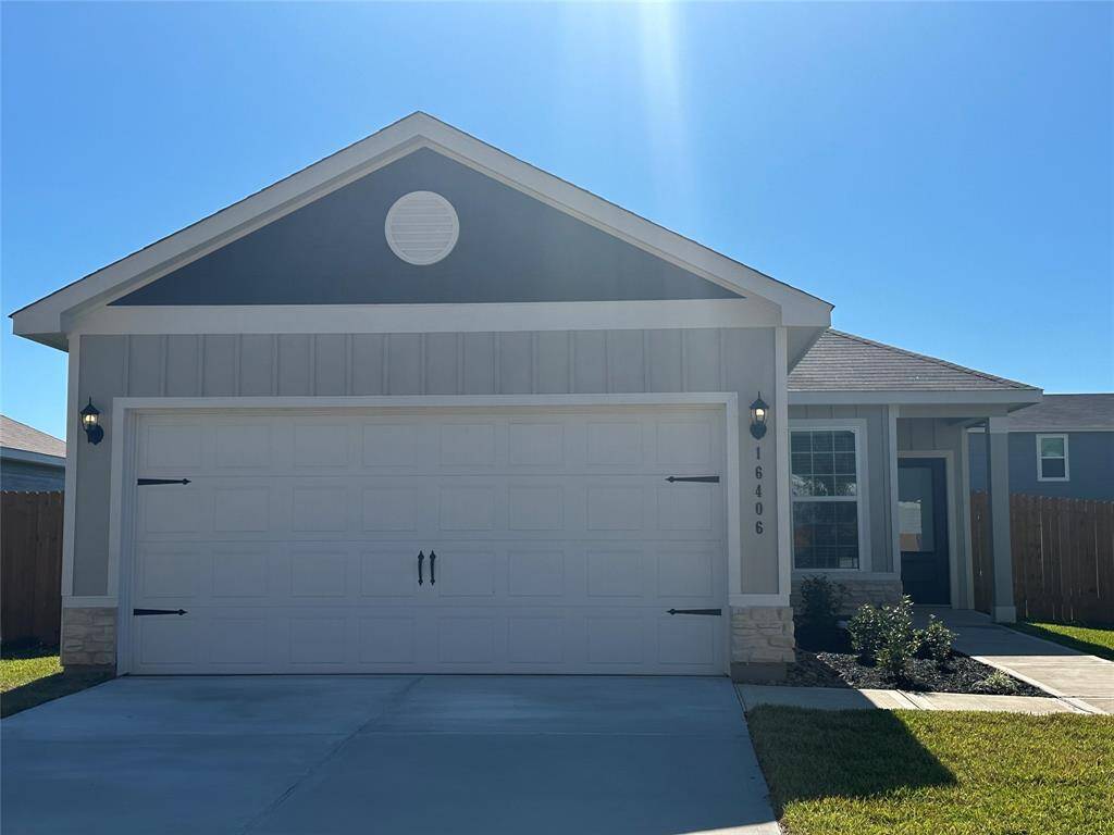 The beautifully landscaped yard, inviting front porch, and expansive windows enhance its curb appeal, giving the home a bright, welcoming look.