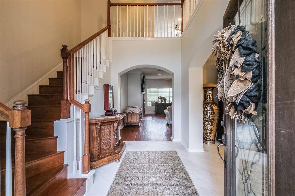 Front entryway features beautiful wooden staircase