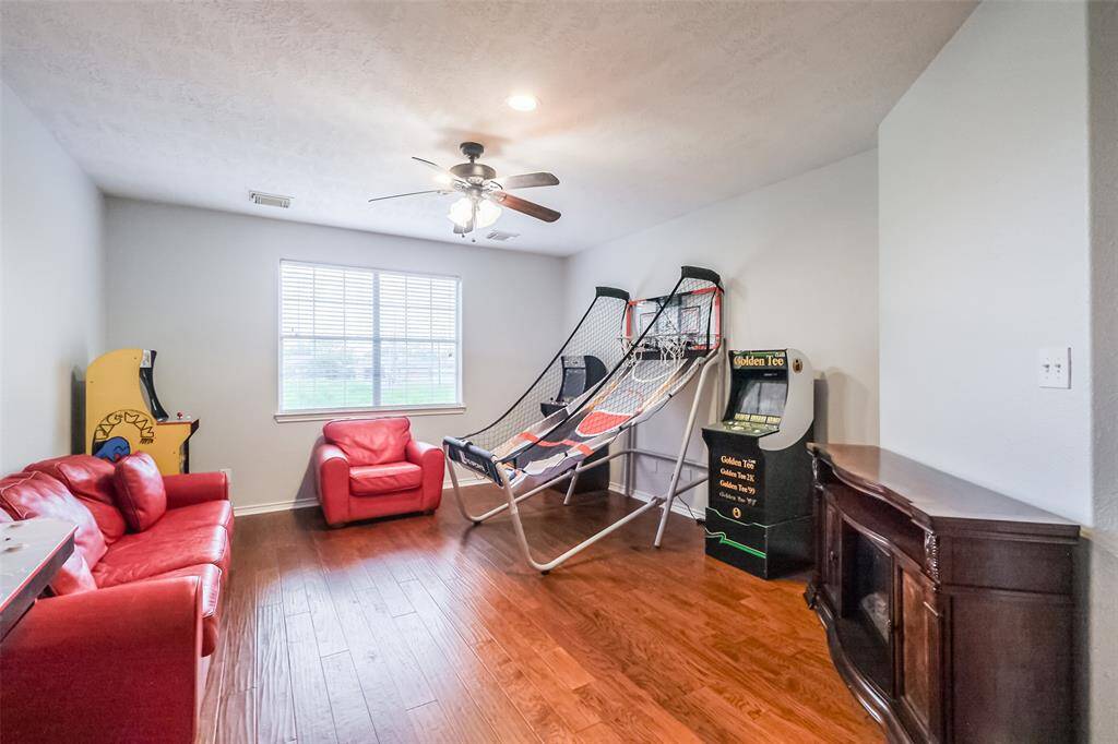 Upstairs game room with beautiful wood floors