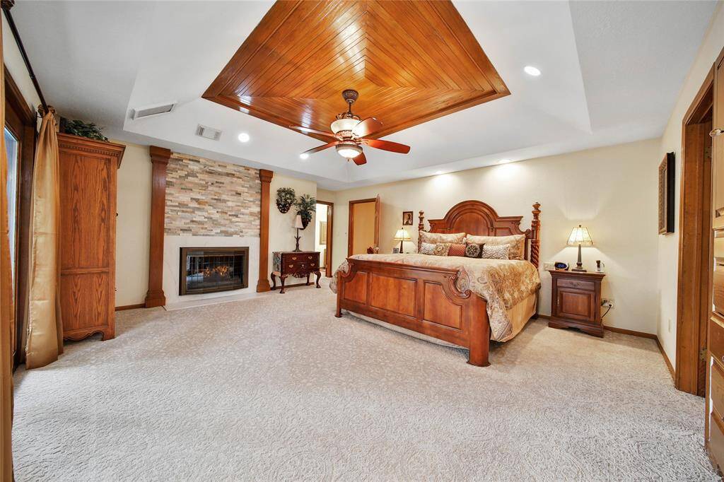 UPSTAIRS huge owner's retreat! Luxurious, cozy and peaceful! Stone gas log fireplace to snuggle up to! Look up at the wood feature ceiling!