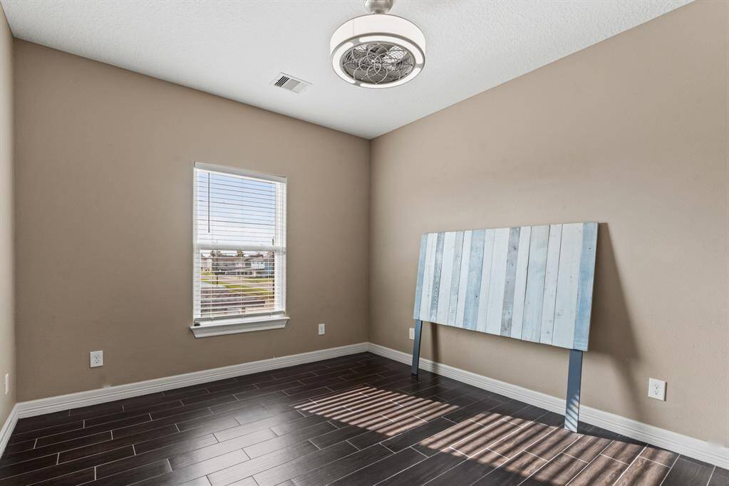 Second bedroom offers natural light and  roomy closet with pocket door.