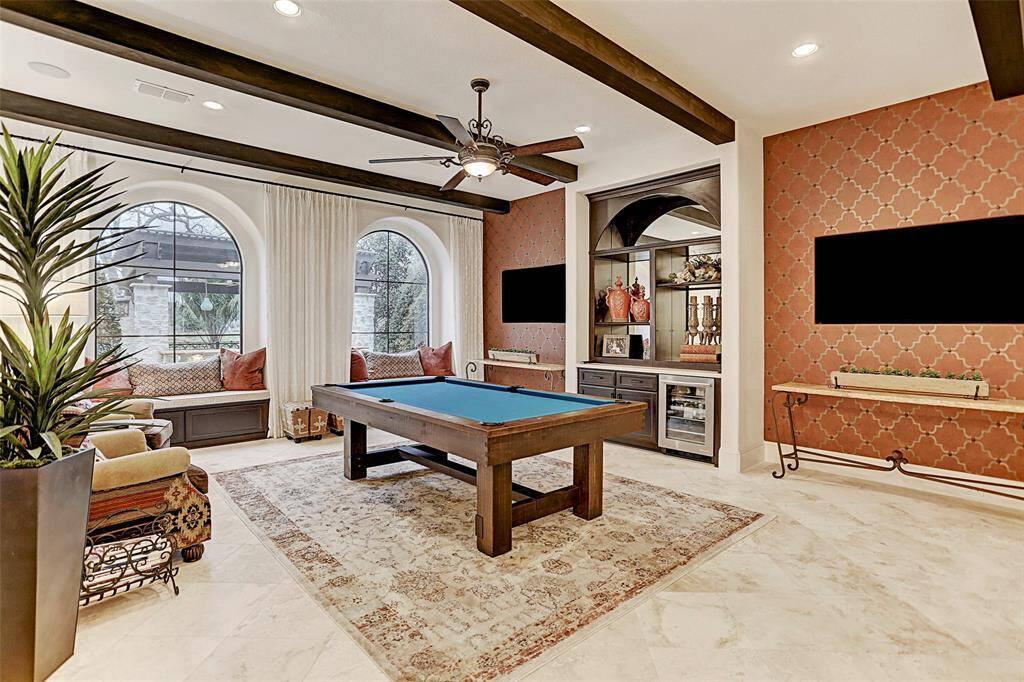 Game Room | You will be inviting all your friends over to enjoy the game room with a built-in bar nook and window seating that overlooks gorgeous views of the backyard paradise